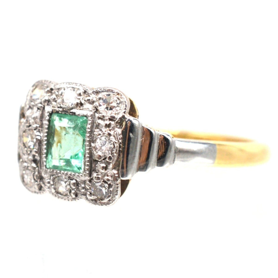 Art Deco 18ct gold and platinum emerald and diamond ring with millegrain setting and stepped shoulders.