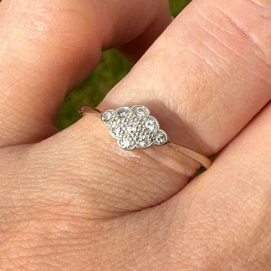 Art Deco 18ct gold diamond cluster ring on hand, showcasing elegant design with nine diamonds in a cluster setting.