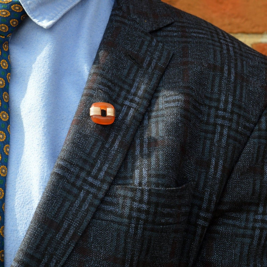 Art Deco 9ct gold carnelian agate brooch on the lapel of a stylish blazer, suitable for any gender.