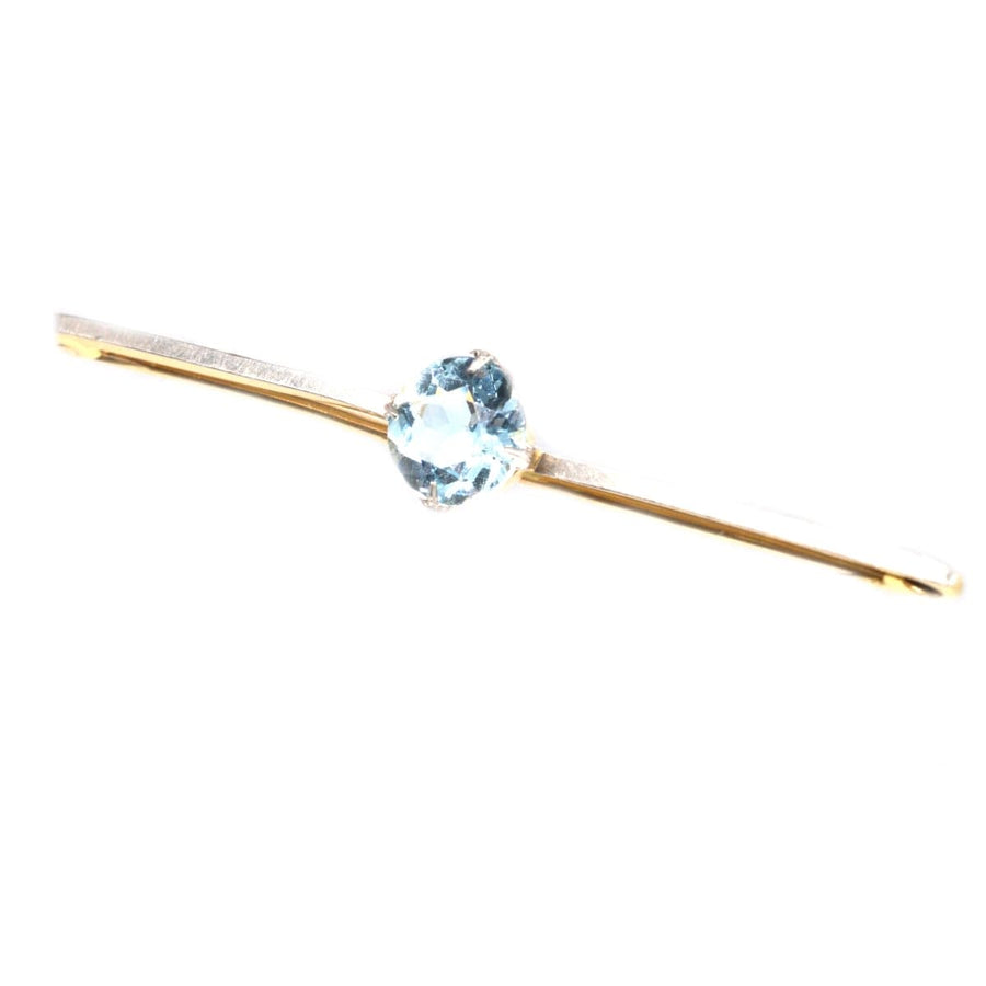 Art Deco platinum and 15ct gold aquamarine bar brooch showcasing a stunning blue aquamarine centerpiece.