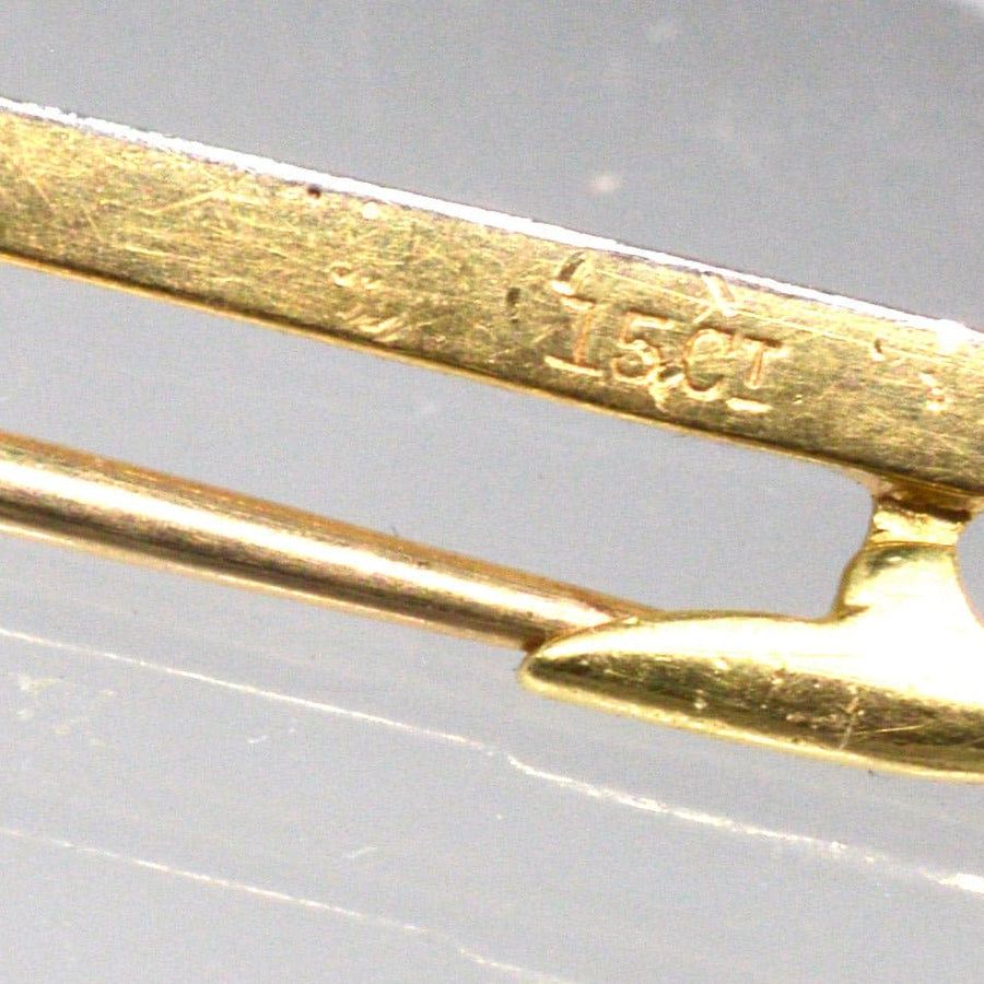 Close-up of 15ct gold marking on an Art Deco bar brooch showcasing its craftsmanship and quality.