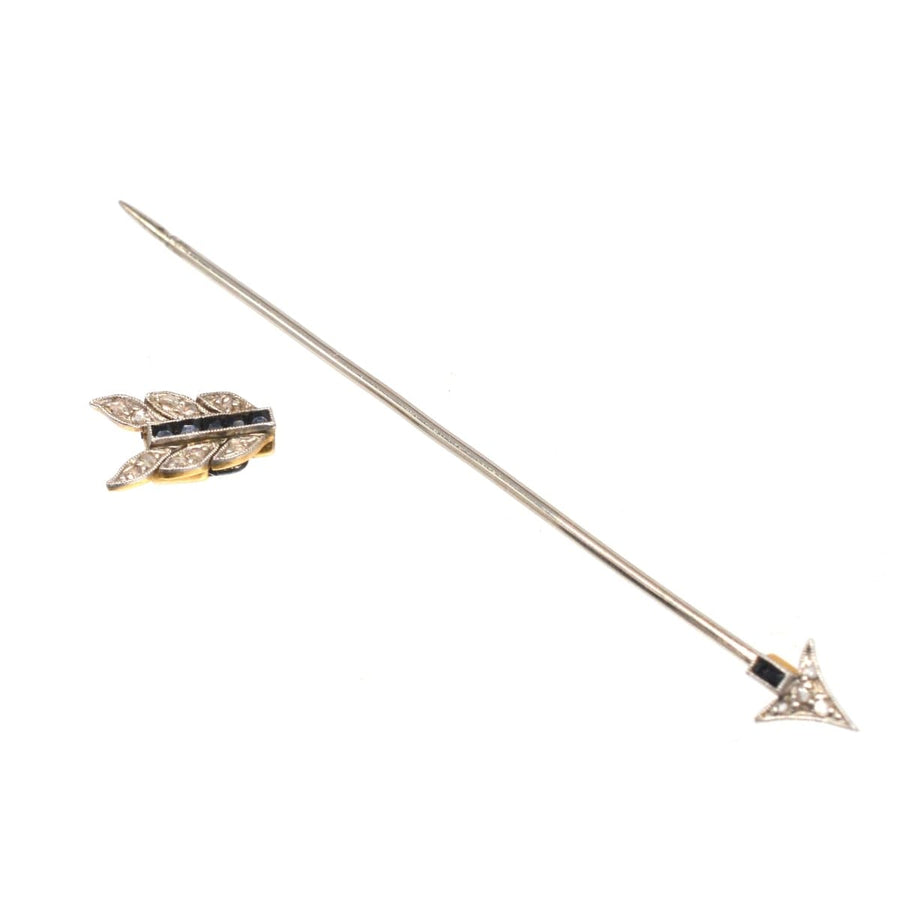 Vintage Art Deco arrow brooch in platinum and gold with black sapphire and diamond accents.