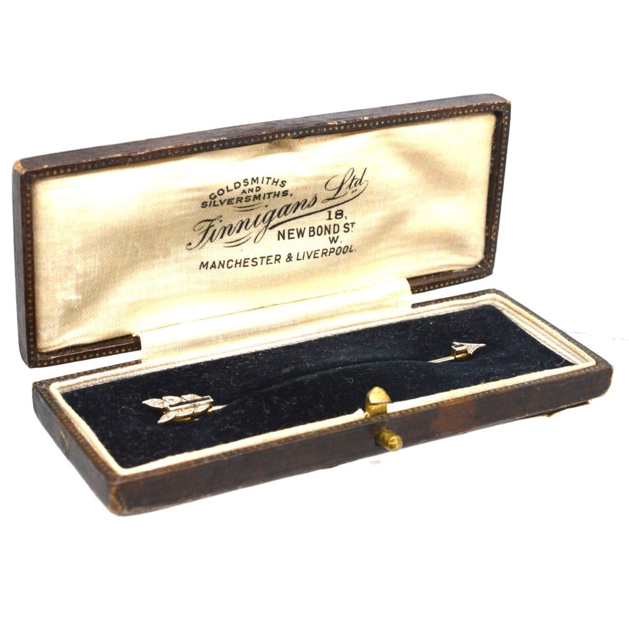 Antique jewelry box showcasing a vintage 1920s Art Deco brooch with a diamond and sapphire arrow design.