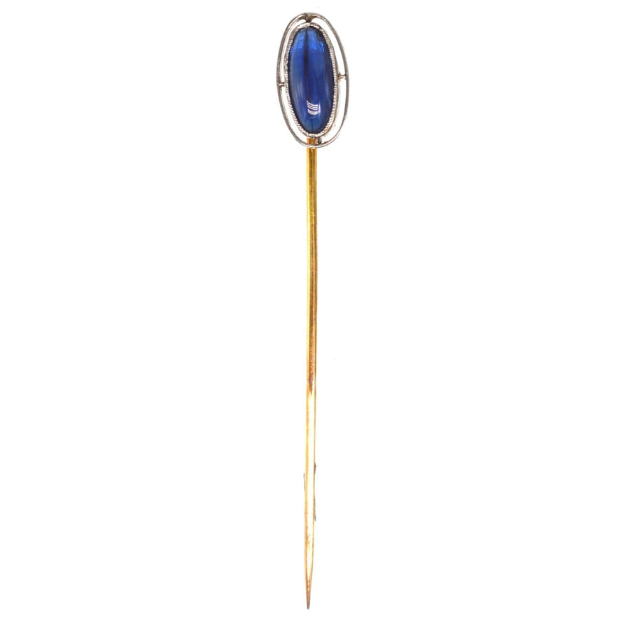 Art Deco platinum and sapphire tie pin, featuring a sapphire within an open circular band, circa 1920s.