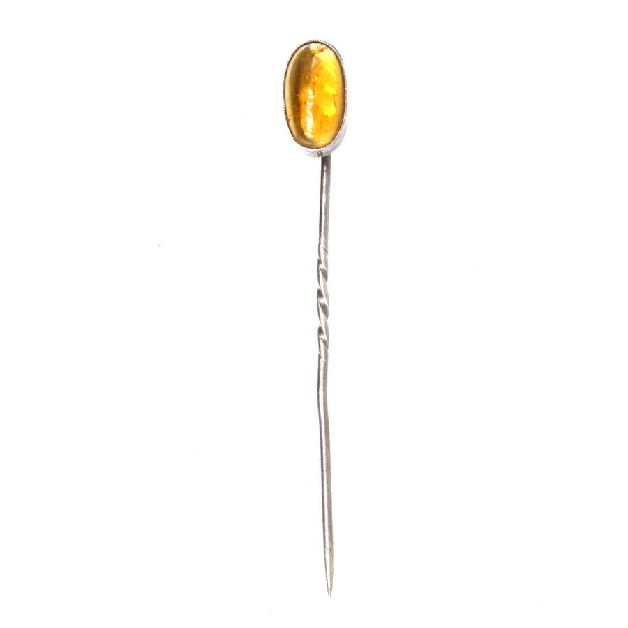 Art Deco silver tie pin featuring natural amber, circa 1920s, with a striking color and elegant design.