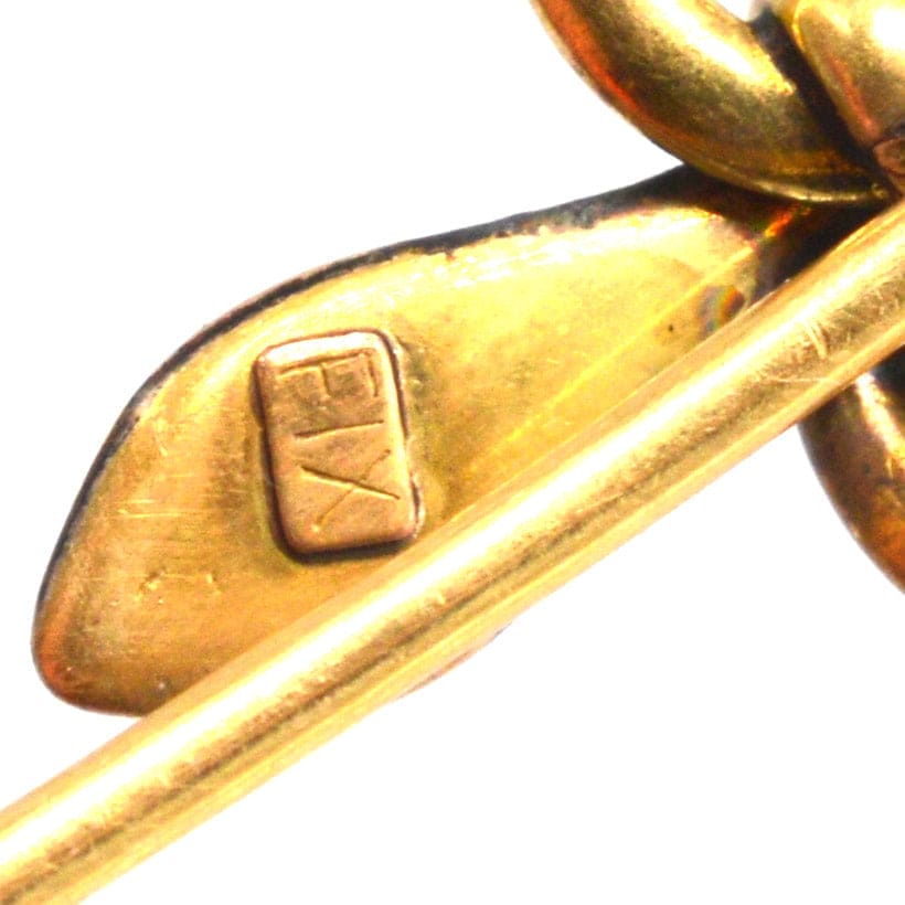 Close-up of Art Nouveau gold snake tie pin showcasing the 'FIX' stamp and craftsmanship details.