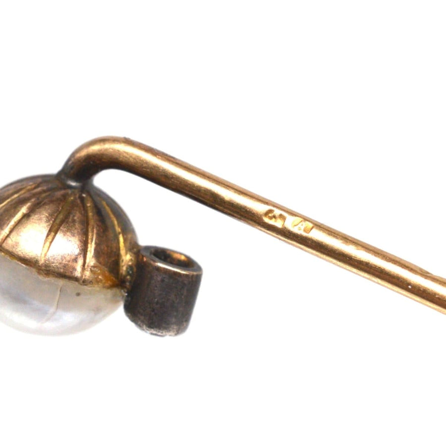 Close-up of Edwardian 14ct gold tie pin featuring natural pearl and diamond, with import hallmarks from Austria.