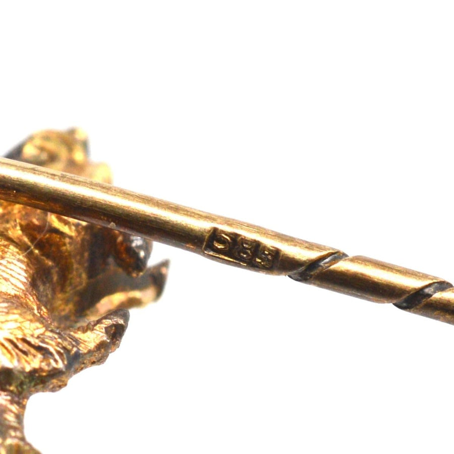 Close-up of a vintage 14ct gold wild boar tie pin showing detailed texture and stamp.