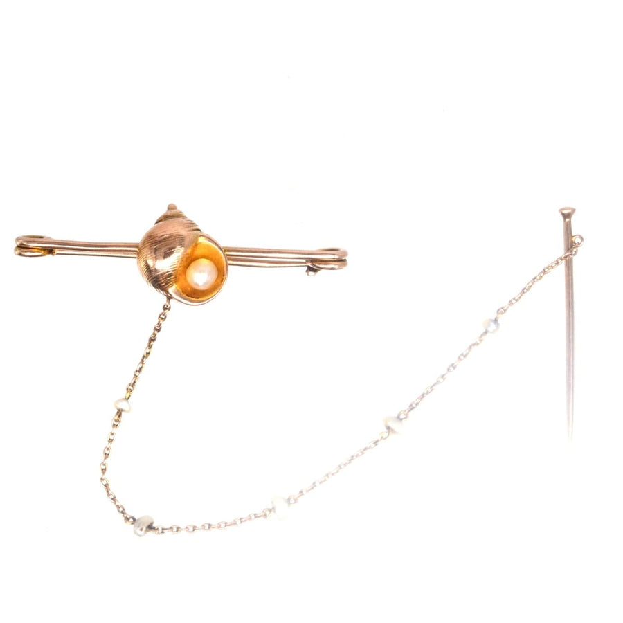 Edwardian 15ct gold bar brooch featuring a seashell and natural pearl, showcasing elegant craftsmanship.
