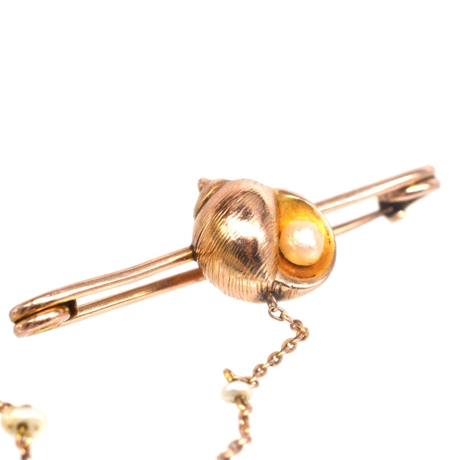 15ct gold bar brooch featuring a seashell and natural pearl chain, perfect gift for seaside lovers.