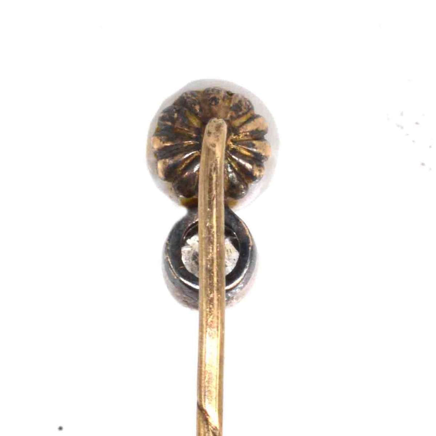 Edwardian 15ct gold pin showcasing a natural pearl and diamond, symbolizing elegance and sophistication.