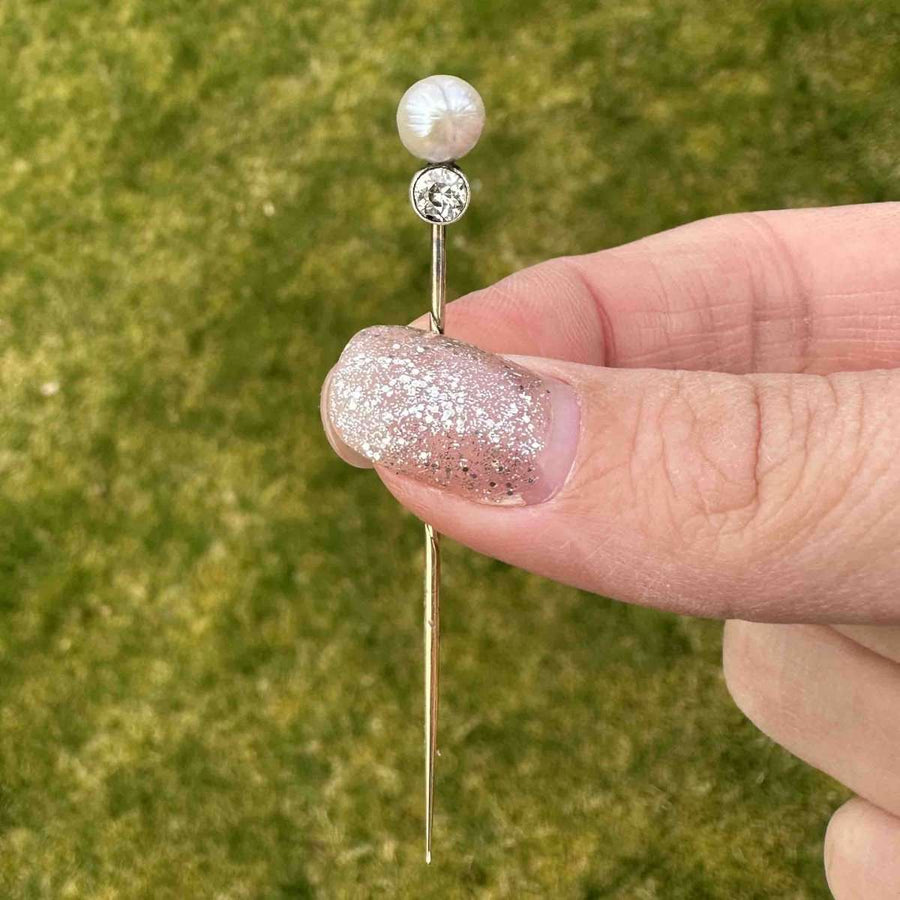 Edwardian 15ct gold tie pin with natural pearl and diamond, showcasing elegance and refinement.