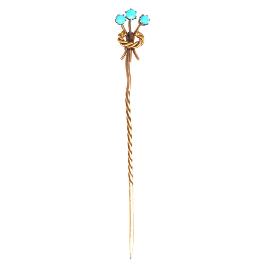 Edwardian 15ct gold tie pin with trio of turquoise stones in a knot pattern, evoking floral beauty and elegance.