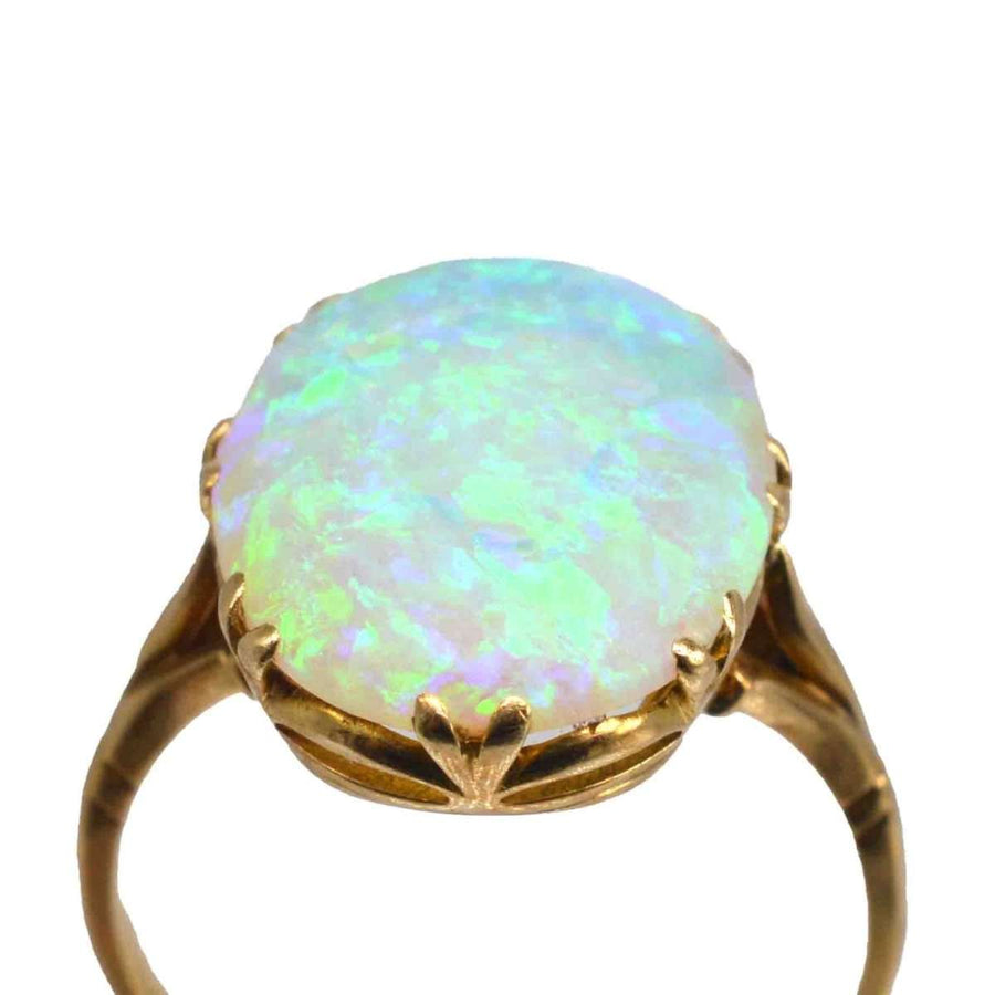 Edwardian 18ct gold opal ring showcasing a large, lustrous opal with vivid green and blue flashes.