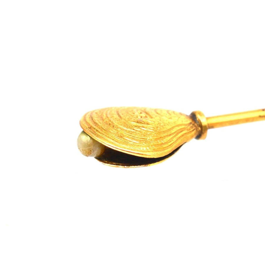 Edwardian 9ct gold oyster shell hat pin with pearl detail, ornate and charming design.