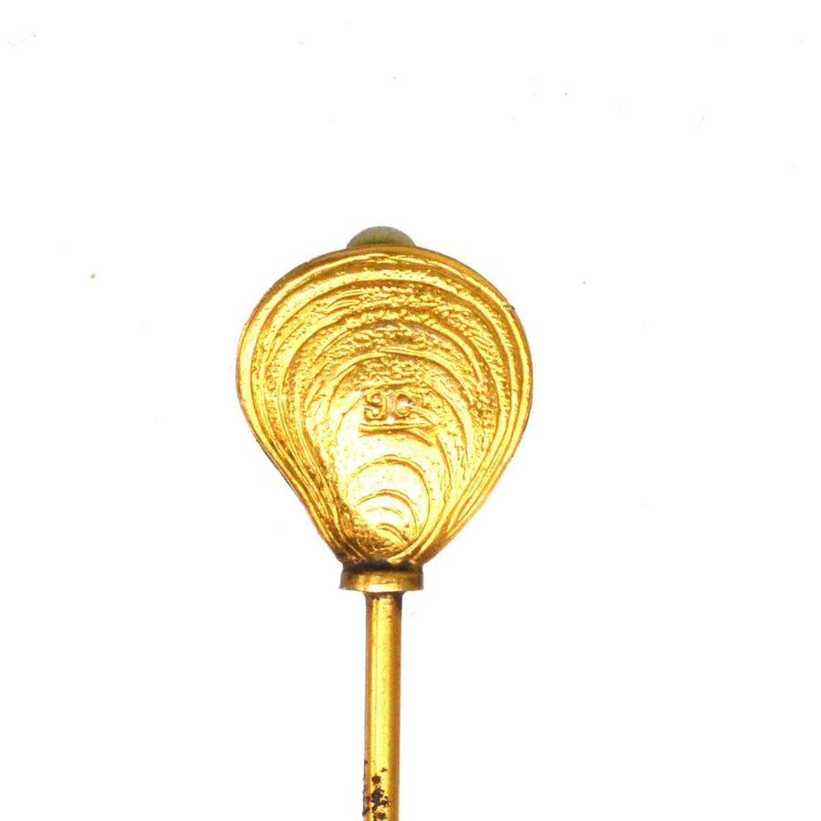Edwardian 9ct gold oyster shell hat pin with pearl, showcasing ornate design and craftsmanship.