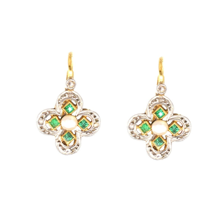 Elegant Edwardian quatrefoil earrings with emeralds, diamonds, and center pearl, perfect for any occasion.