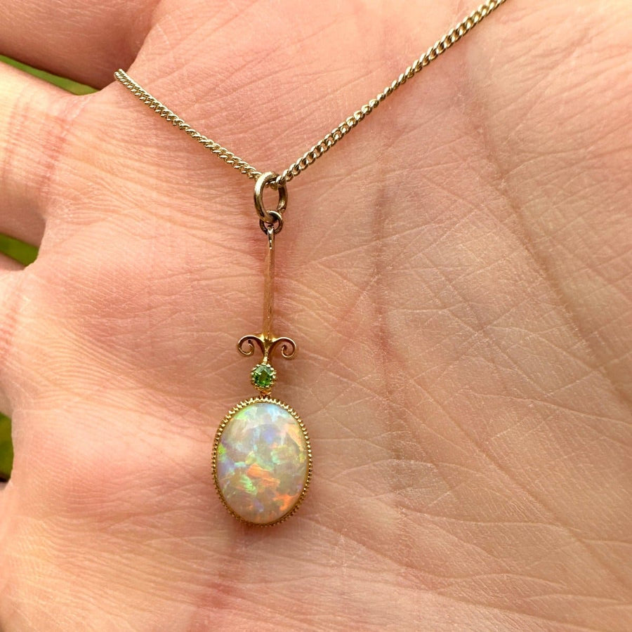 Edwardian opal pendant with green garnet on a modern 9ct gold chain, showcasing fine craftsmanship.