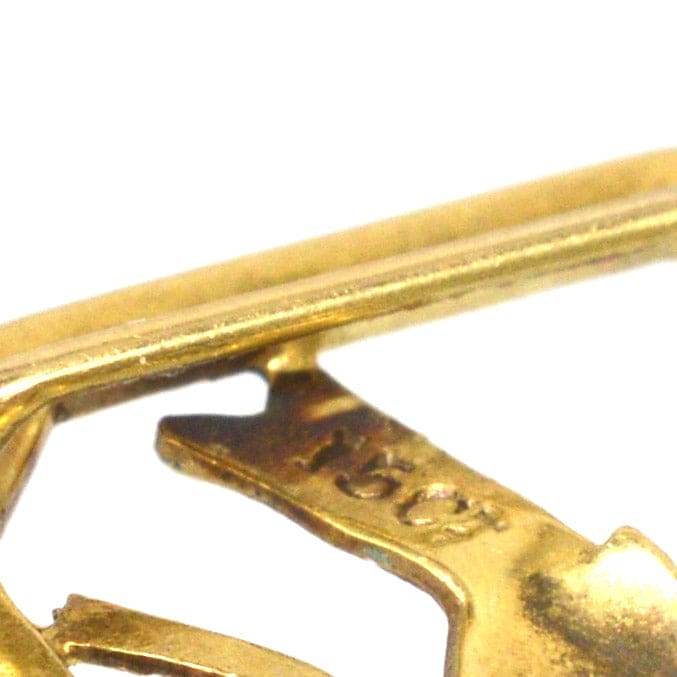 Close-up of the 15ct gold stamp on an Edwardian enamel buckle featuring a blue tit bird.