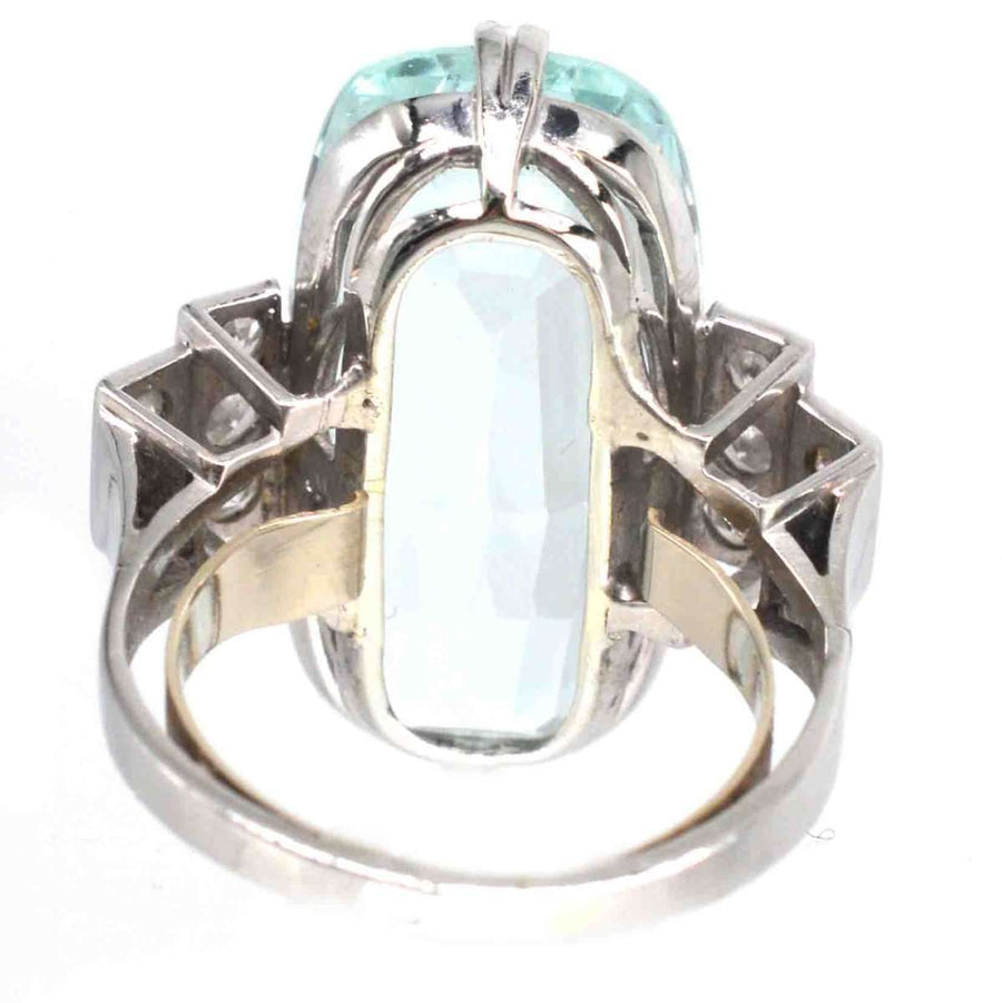 Vintage platinum ring featuring a 12-carat aquamarine and diamond detailing, showcasing Art Deco design elegance.