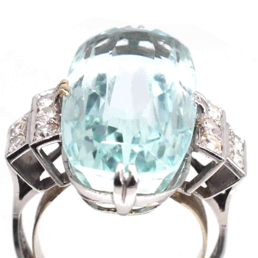 1930s French Art Deco platinum ring featuring a large 12-carat aquamarine and diamond accents.
