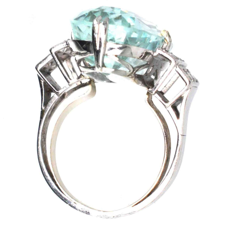 French Art Deco platinum ring featuring a 12-carat aquamarine and diamond accents, showcasing elegant geometric design.