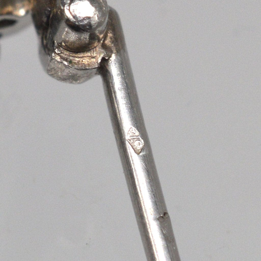 Close-up of the stamp on a French Art Deco platinum brooch showcasing its intricate detailing.