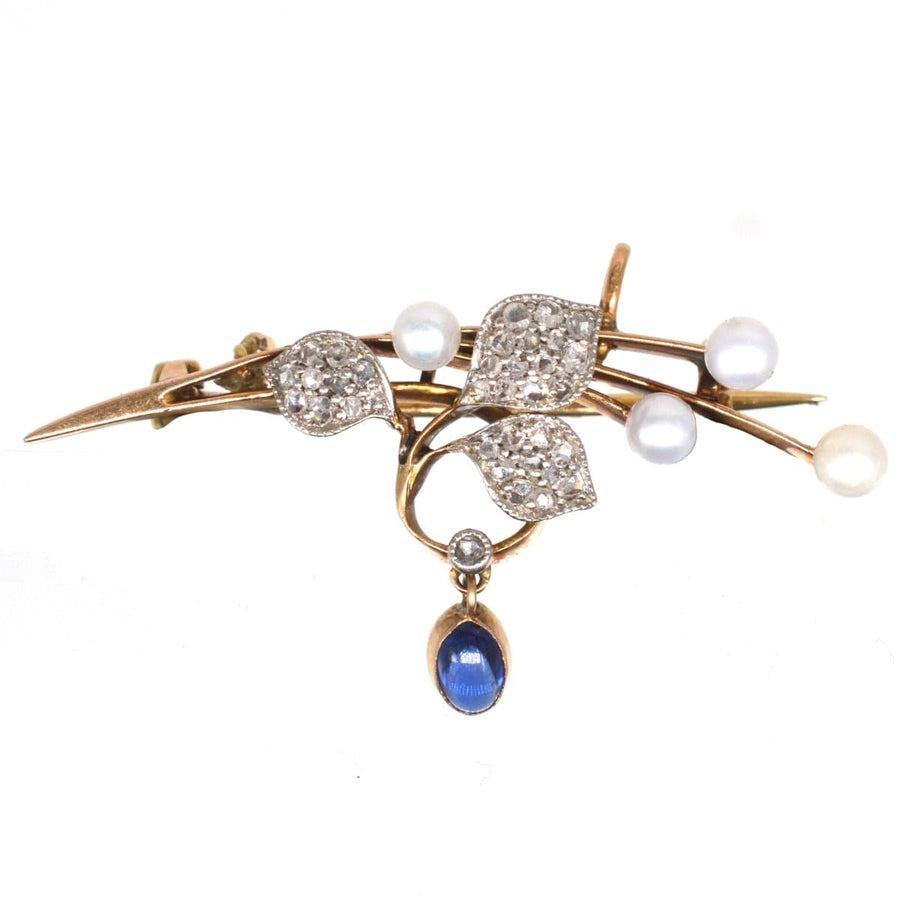 French Art Nouveau brooch featuring 14ct gold, pearls, diamond leaves, and a cabochon sapphire drop.