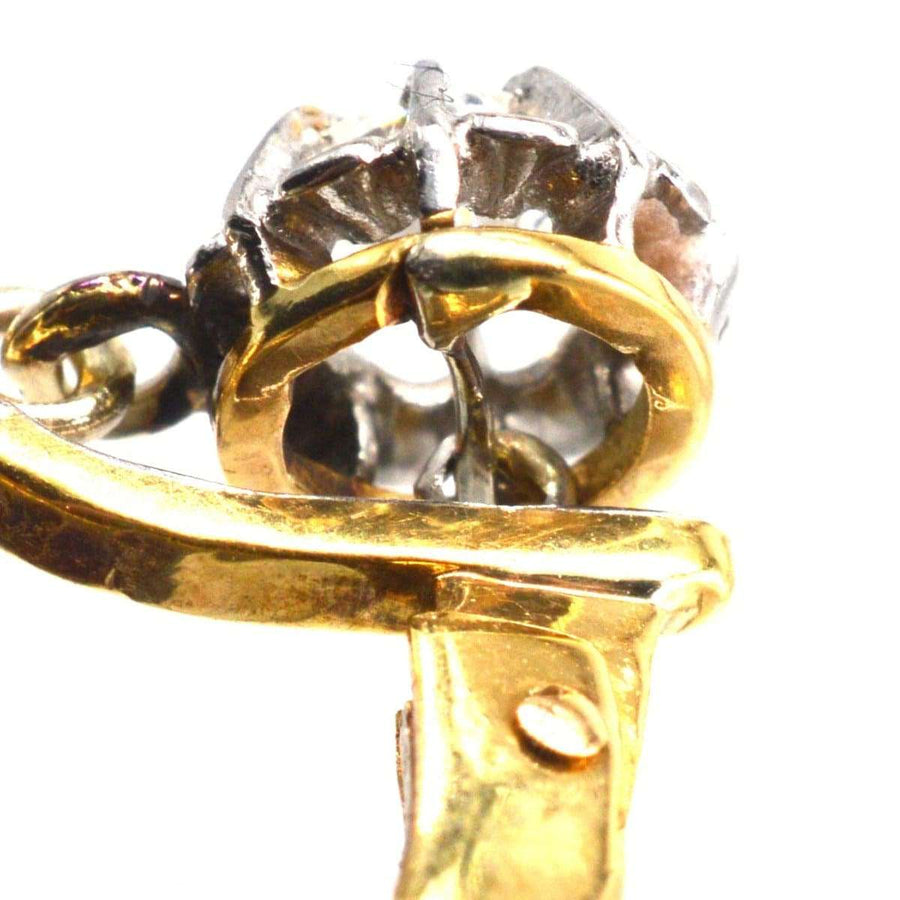 Close-up of French Belle Epoque 18ct gold and platinum diamond drop earring showing intricate claw setting.