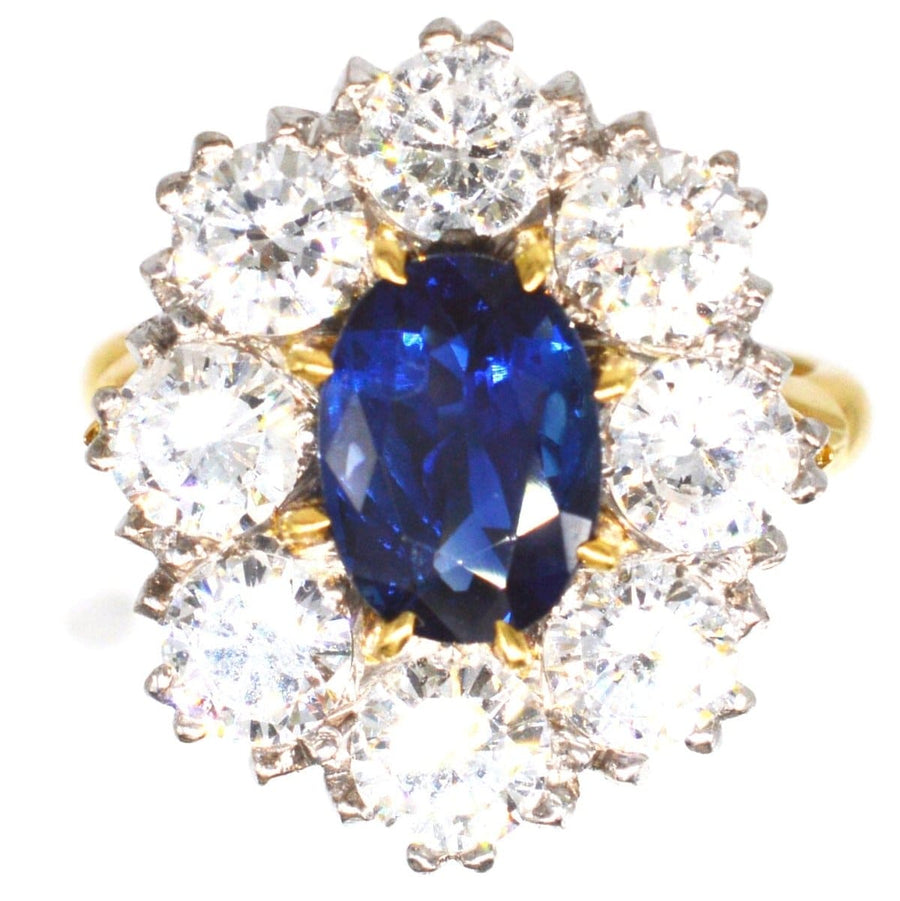 Large mid century sapphire and diamond cluster ring featuring a 1.9 carat sapphire surrounded by white diamonds.