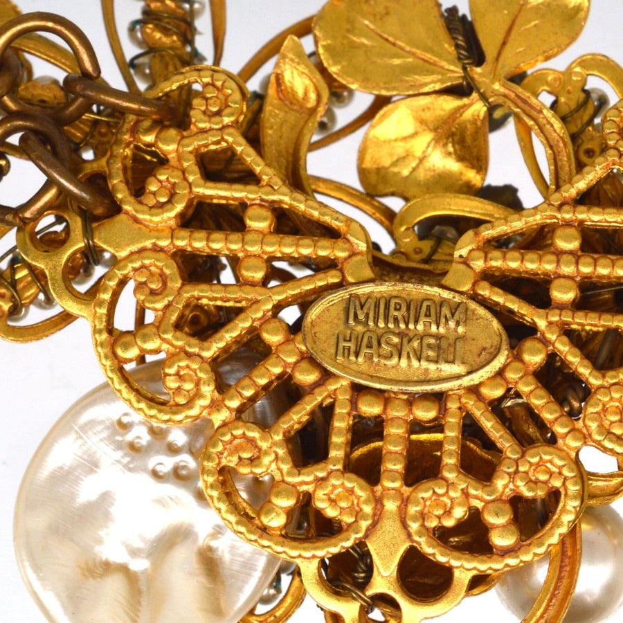 Miriam Haskell signed faux pearl and gold-tone floral necklace featuring intricate detailing and vintage charm.