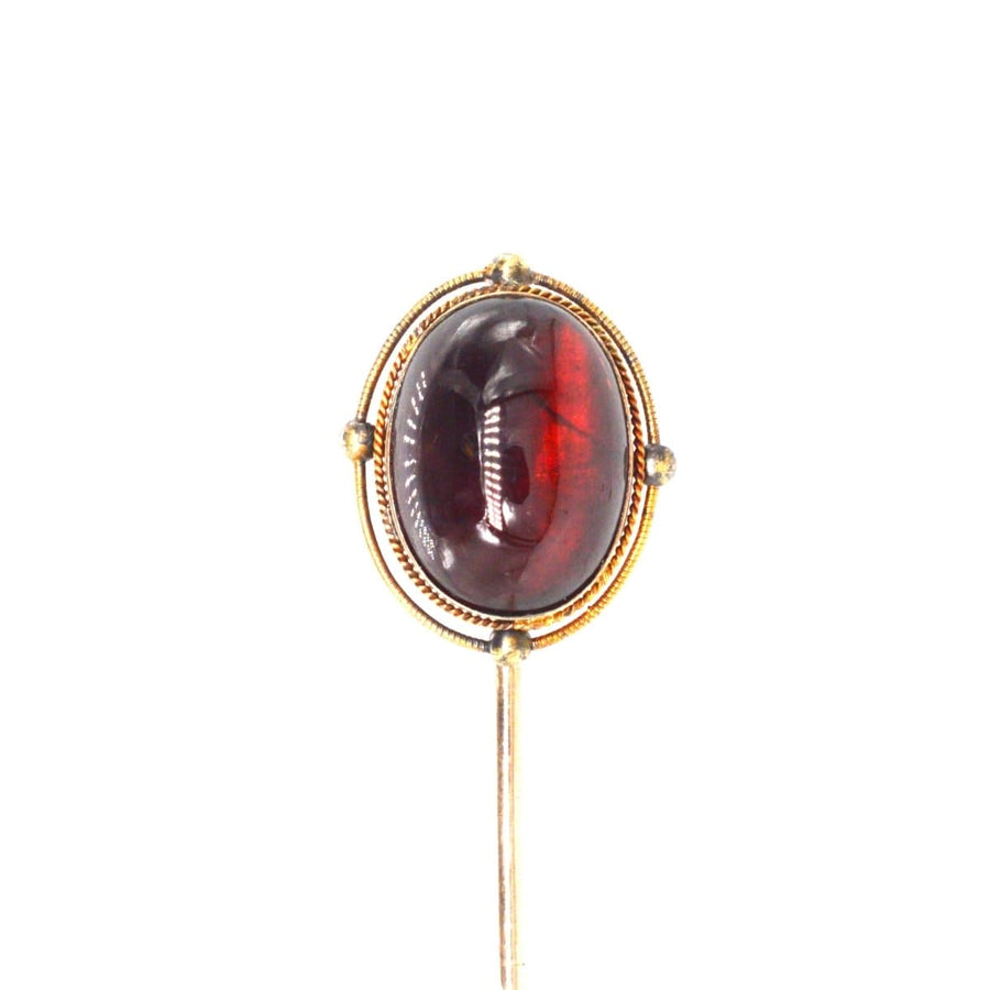 Victorian 15ct gold tie pin featuring a stunning cabochon garnet, showcasing timeless elegance and beauty.