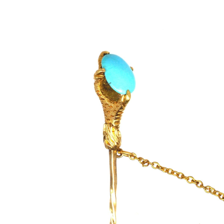 Victorian 15ct gold tie pin with eagle claw holding turquoise stone, symbolizing love and care.