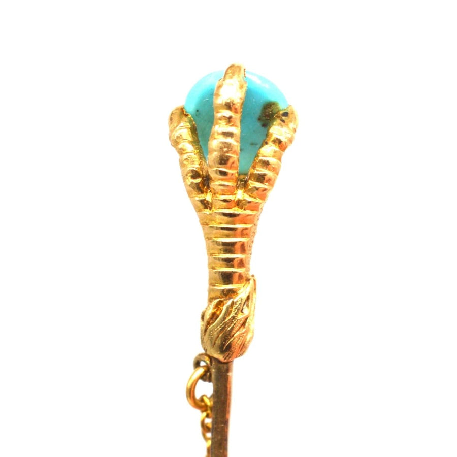 Victorian 15ct gold tie pin featuring an eagle claw holding a turquoise stone, symbolizing love and remembrance.