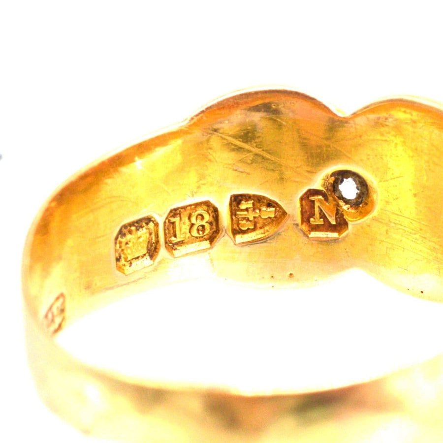Close-up of Victorian 18ct gold ring showing stamp and craftsmanship details.