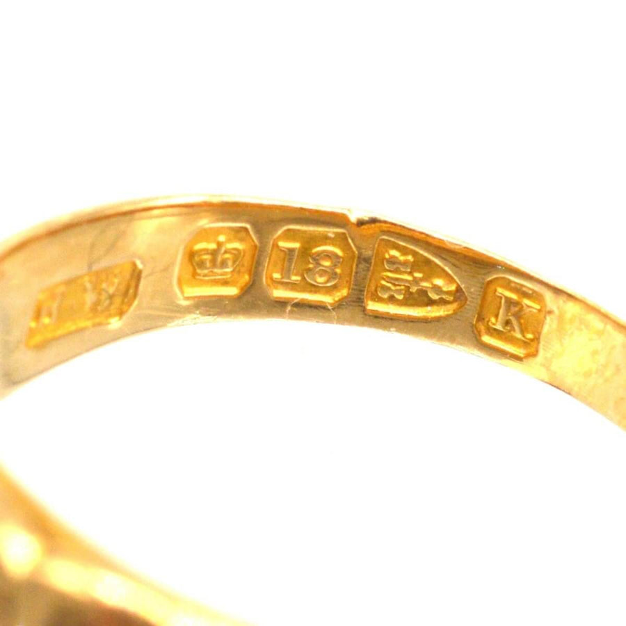 stamp details of a Victorian 18ct gold band keeper ring, including maker's mark and purity stamp.