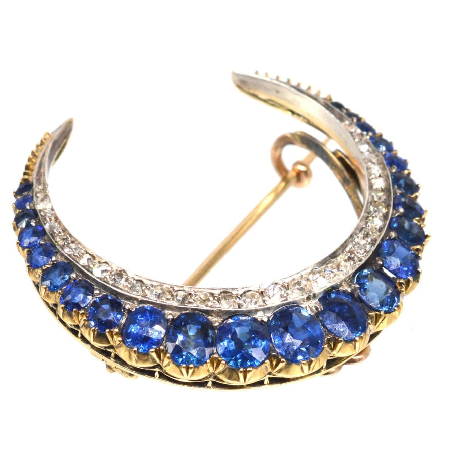 Victorian 18ct gold crescent moon brooch adorned with sapphires and diamonds, showcasing exquisite craftsmanship.
