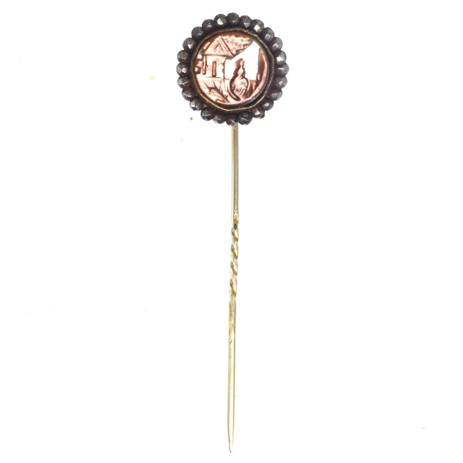 Victorian cut steel tie pin featuring carved brown mother of pearl with scenery of a house and lady, 19th century design.