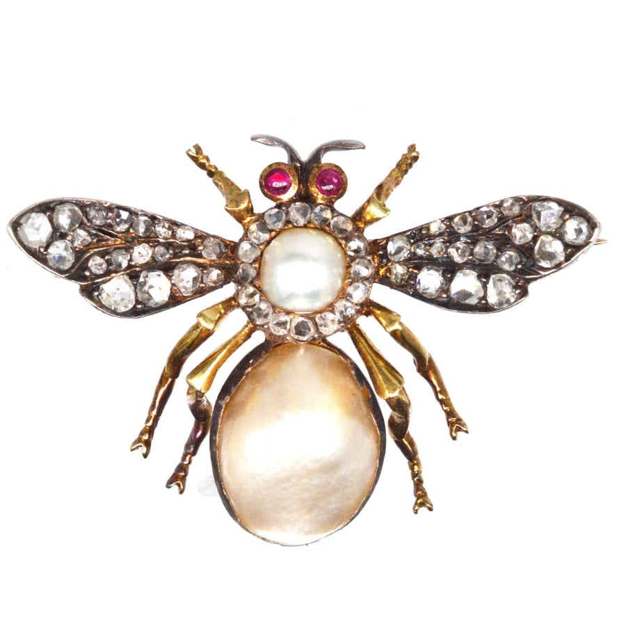 Victorian bee brooch featuring pearls, diamonds, and cabochon rubies, showcasing nature-inspired elegance.