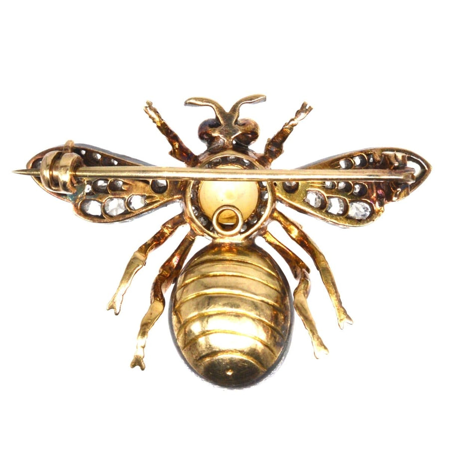 Victorian bee brooch featuring pearls, diamonds, and cabochon rubies, a nature-inspired jewelry piece.