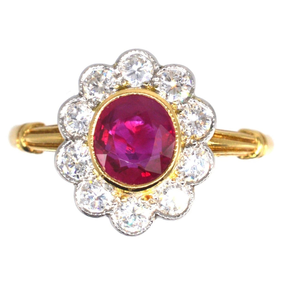 Vintage 18ct gold ring featuring Burma ruby centerpiece surrounded by diamond cluster, perfect for engagement or July birthdays.