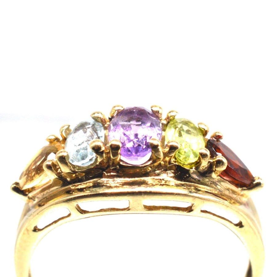 Vintage 9ct gold five stone ring featuring citrine, aquamarine, amethyst, peridot, and garnet gemstones.