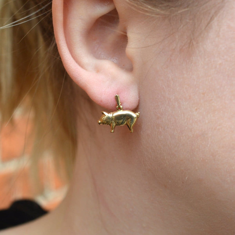 Stylish vintage 9ct gold pig earrings worn on a woman's ear, perfect for everyday fashion.