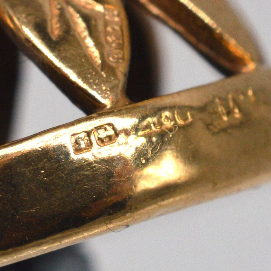 Close-up of the stamp on a 9ct gold pendant from 1942, showcasing its authenticity and craftsmanship.