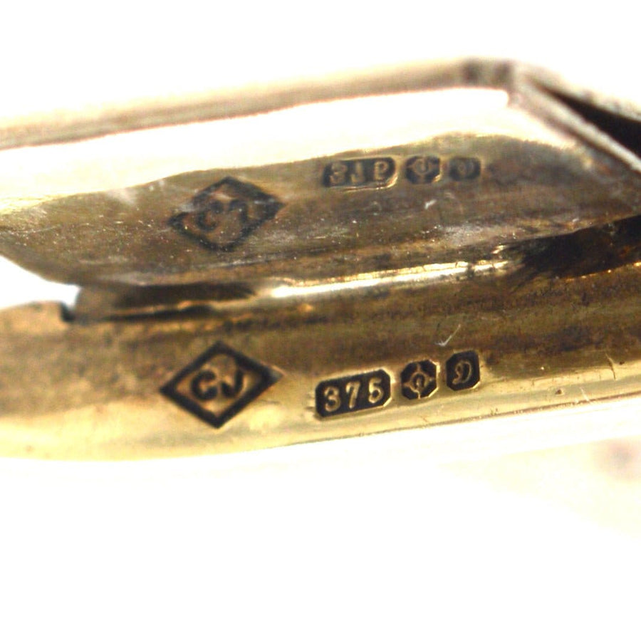 Close-up of stamp stamps on a 9ct gold weave bracelet showcasing quality and craftsmanship.