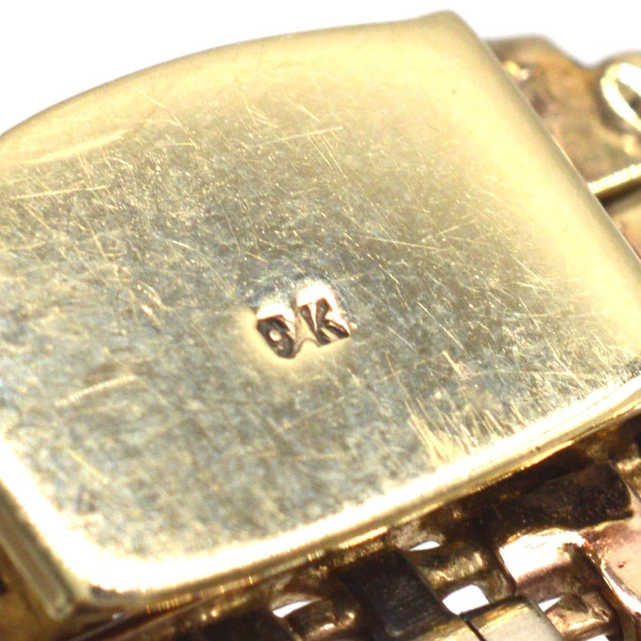 Close-up of the stamp on a 1970s 9ct gold weave bracelet, showcasing quality and craftsmanship.