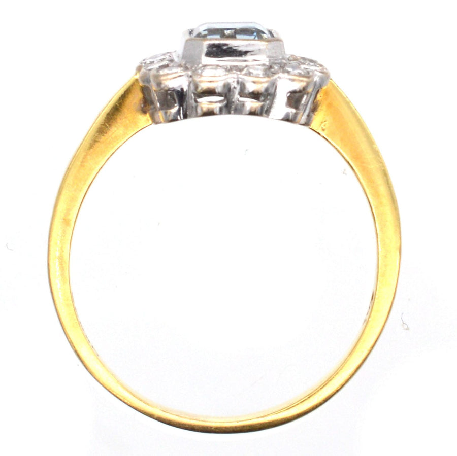 Vintage 18ct gold aquamarine and diamond cluster ring, featuring a sparkling central aquamarine and diamond accents.