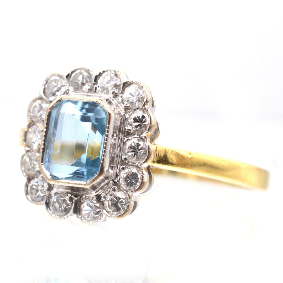 Vintage 18ct gold aquamarine and diamond cluster ring with elegant design, showcasing a stunning central aquamarine stone.