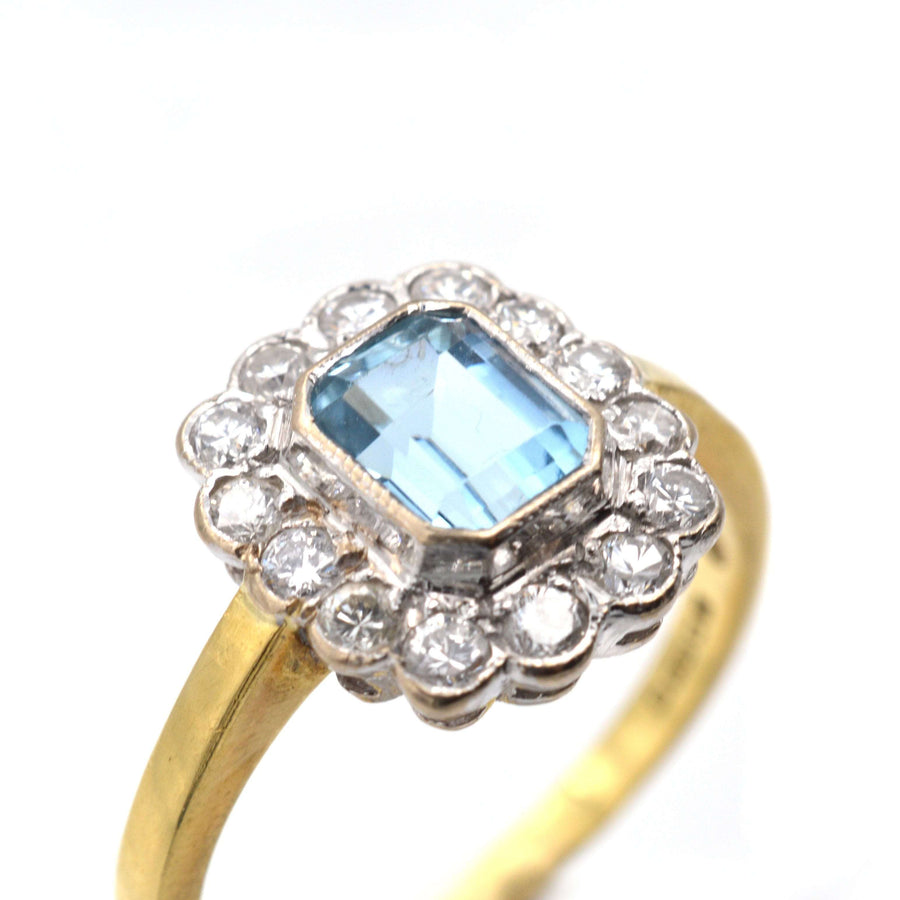 Vintage 18ct gold aquamarine and diamond cluster ring, featuring a central aquamarine and sparkling diamonds.