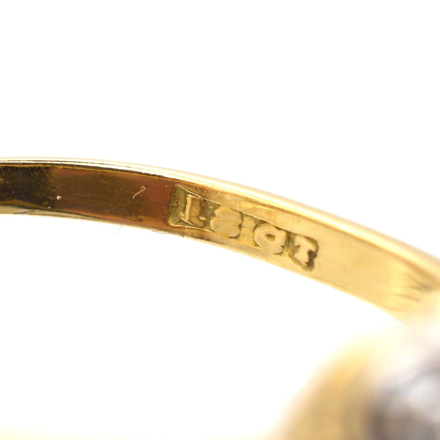 Close-up of 18ct gold stamp inside Art Deco diamond cluster ring, showcasing quality craftsmanship.